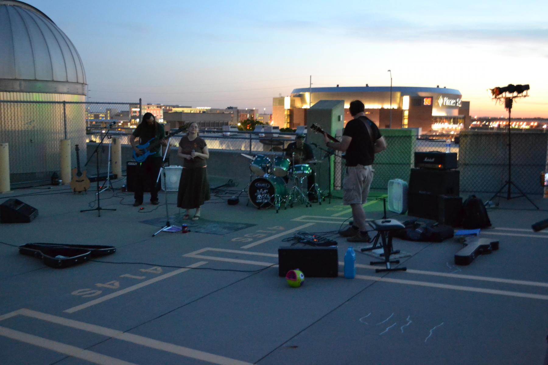 Bandmembers perform next to the Student Observatory.
