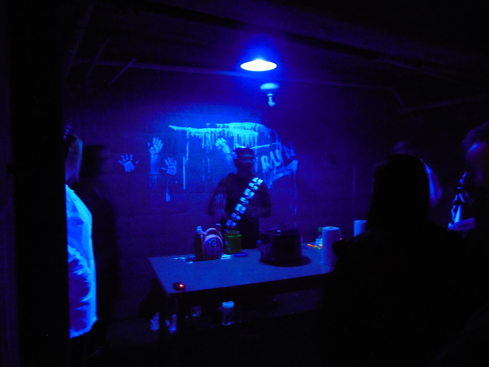 SPS student demonstrates underneath a blacklight