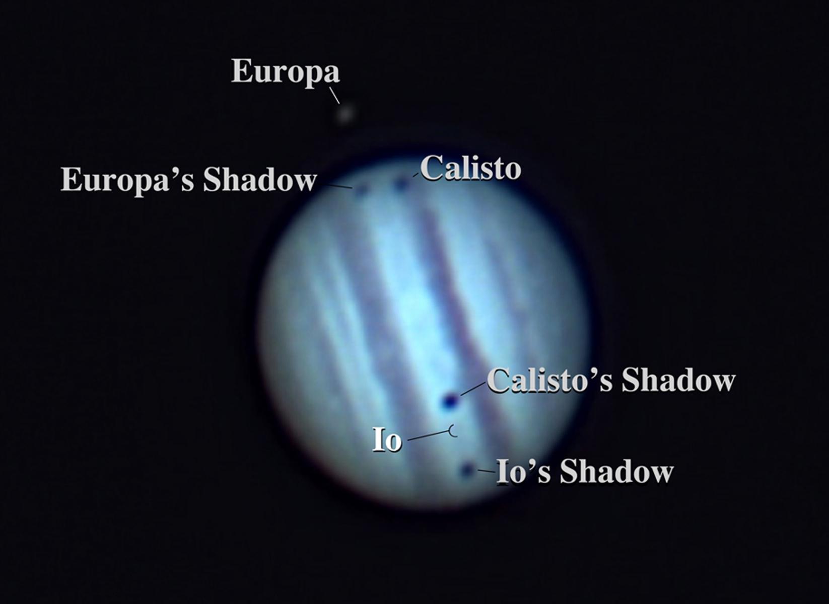 Europa, Calisto, and Io create shadows across the surface of Jupiter, as seen from Earth